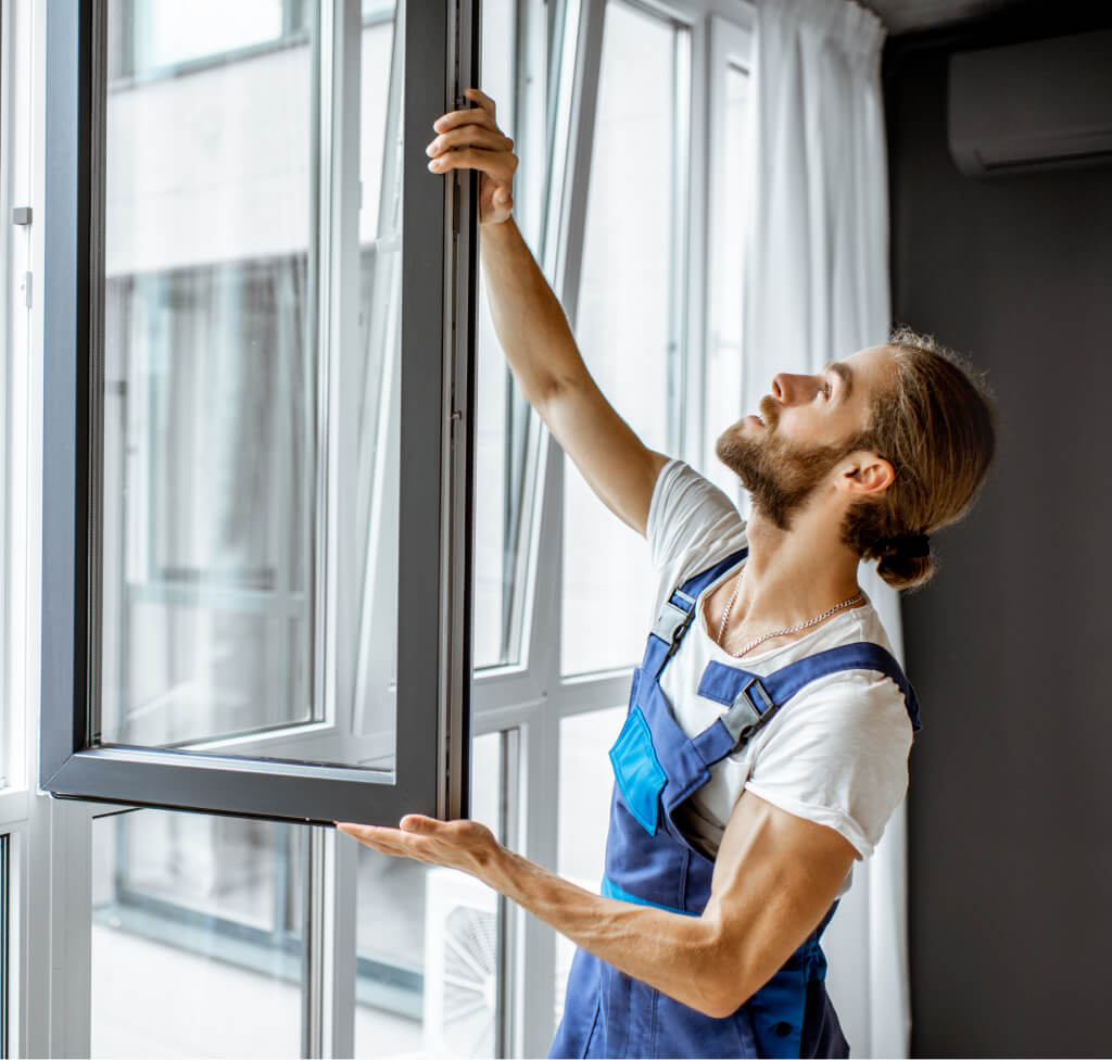 workman adjusting window frames at home